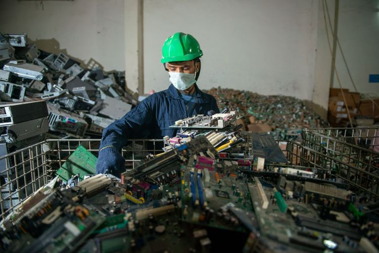 a person who sorts through a mountain of electronic waste